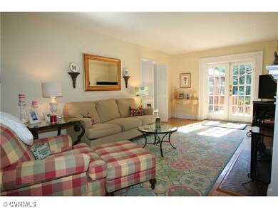 Living Room - French doors open to the two-tiered deck and double louvered doors lead to the den/study.