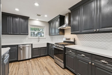 The renovated kitchen features high-end appliances, including a 2023 GE gas stove/range and a 2023 GE dishwasher, adding modern efficiency to the space.