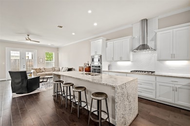 Open concept kitchen with granite waterfall island