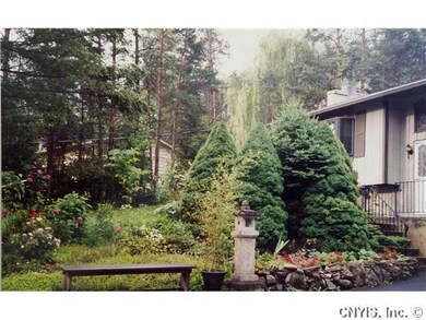 Exterior Front. Flowers grace the entry-way of thi