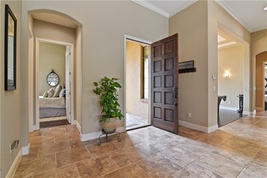 A guest bedroom is located off of the foyer with a