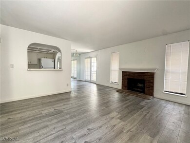 Unfurnished living room featuring wood finished fl