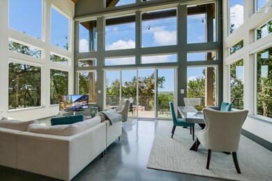 Sunroom / solarium with a towering ceiling and fi
