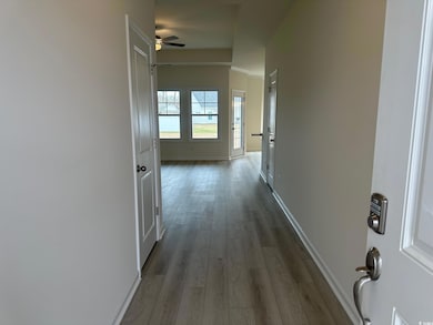 Hallway featuring baseboards and wood finished flo