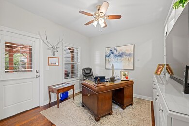 Office space with baseboards, wood finished floor