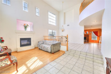 Living area with a high ceiling, a glass covered f