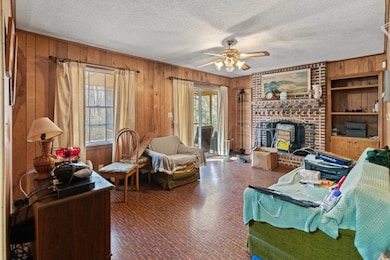 Living area with plenty of natural light, wood wal