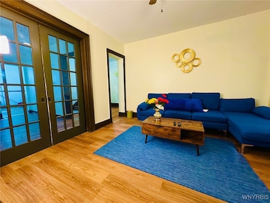 A large living room has a pocket door and a ceilin