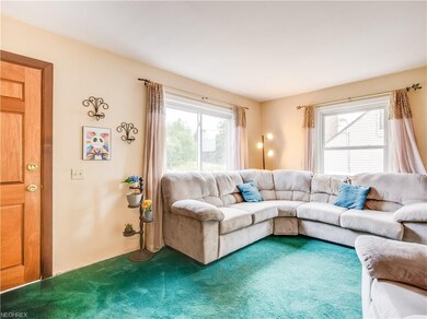Family room with large windows offers lots of natu