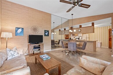 A view from the living area into the dining area and kitchen.