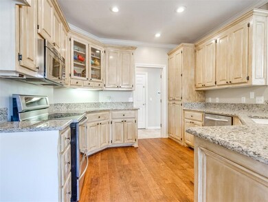 Kitchen with light stone counters, recessed lighti