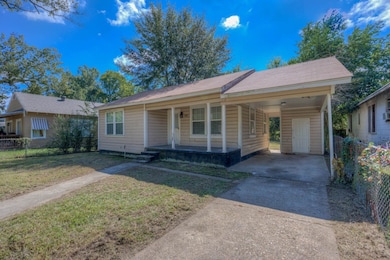 Bungalow-style home featuring a porch, an attached carport, and driveway