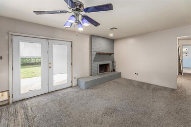 Unfurnished living room featuring ceiling fan, car