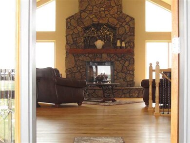 Moss rock gas fireplace surrounded by a wall of wi