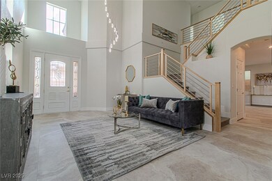 Foyer featuring arched walkways, a towering ceilin