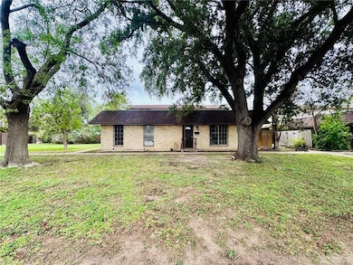 Ranch-style house with brick siding and roof with shingles