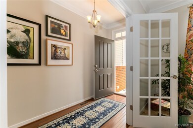 Entrance foyer featuring crown molding and light h