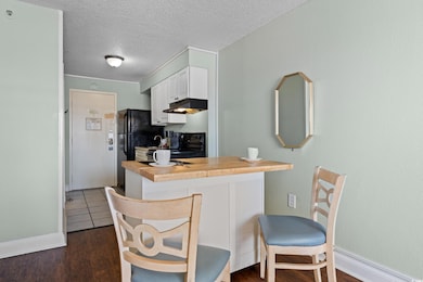 Kitchen featuring baseboards, a textured ceiling, 