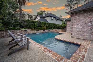 This pool and spa have a timeless design with real brick coping and elegant water features.