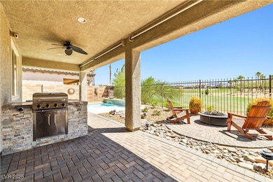 Patio with built-in BBQ, pool and view of the golf