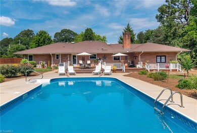 Pool looking toward back of house with three tiered deck.