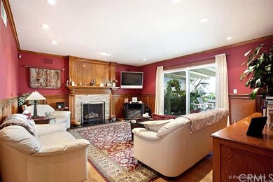 The living room has custom paint, wainscoting, bas