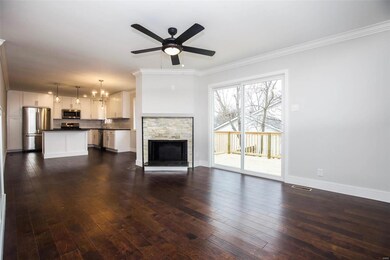 Family room with wood burning fireplace and new sl