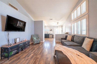 Living area with wood finished floors, ceiling fan