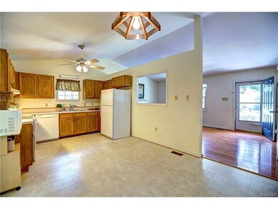 Large Kitchen with Eat In Area and Door to the Scr