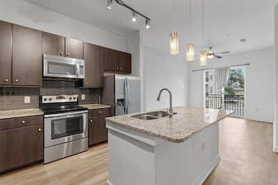 Kitchen featuring stainless steel appliances, dar