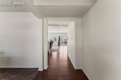 Hallway with baseboards and dark wood finished flo