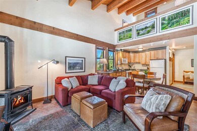 Spacious living room with elevated ceilings, wood 