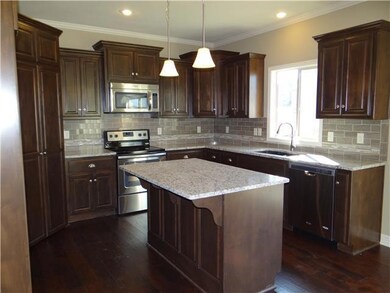 Kitchen with center island, granite counters, stai