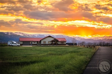 Mountains on the horizon catch the glow of both su