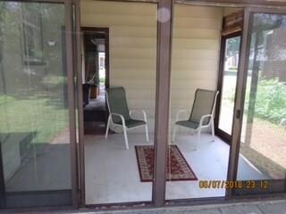 Inviting enclosed patio with sliding glass doors.