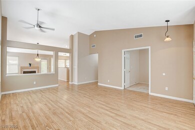 Unfurnished living room featuring a ceiling fan, l