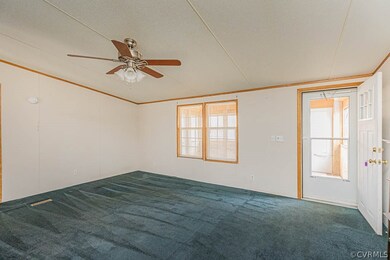 Carpeted empty room with a textured ceiling and ce