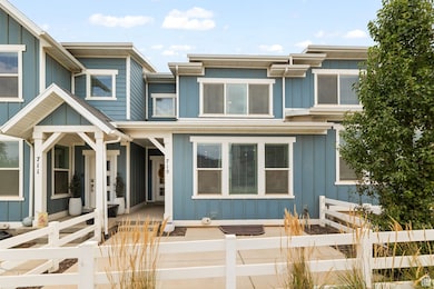View of front of property featuring a fenced front yard, board and batten siding, and a gate