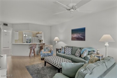 Living room featuring ceiling fan and light hardwo