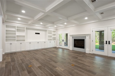 Unfurnished living room with french doors, dark wo