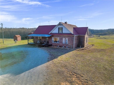 View of front of house featuring a front lawn, a s