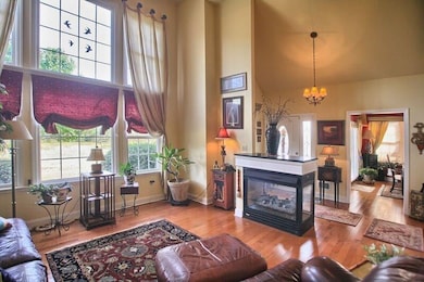 DRAMATIC TWO STORY WINDOWS IN FAMILY ROOM.