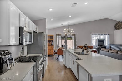 Kitchen featuring stainless steel appliances, vaul
