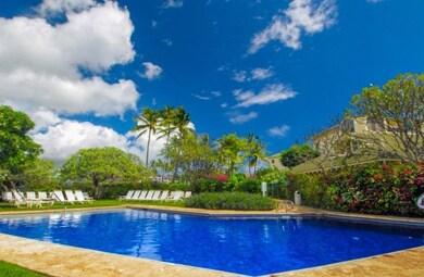 The Manualoha condominium pool is in a beautiful setting with an amazing ocean view situated just across the street from Brennecke's Beach/Poipu Beach.