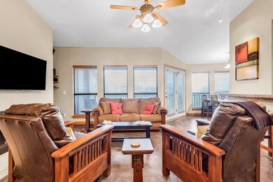 Living room featuring track lighting, ceiling fan