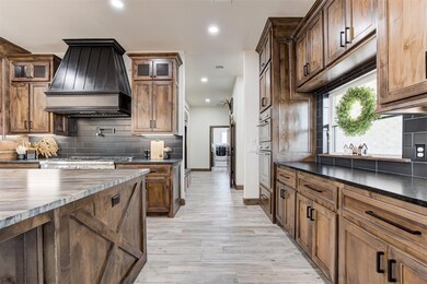 Kitchen with stainless steel gas stovetop, stove, 