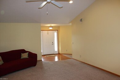 Foyer with wood floor seen from vaulted great room