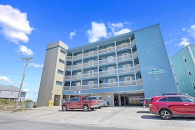 View of property featuring uncovered parking