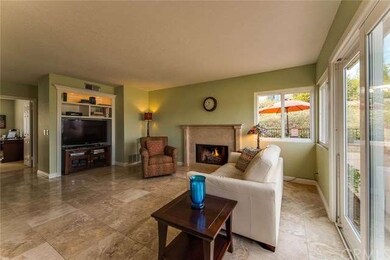 Family Room has travertine tile floors and built-i