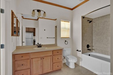Full bathroom featuring ornamental molding, vanity